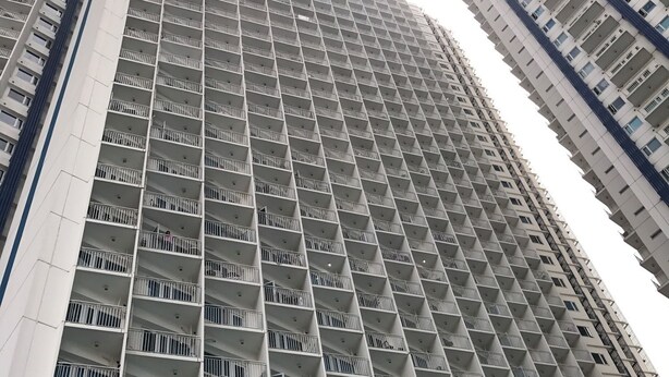 A high-rise building with a uniform facade, featuring numerous balconies and windows. - SM Jazz Residence by Good Rent (Makati)