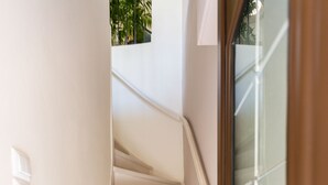 A staircase leading to a door with a glass panel.