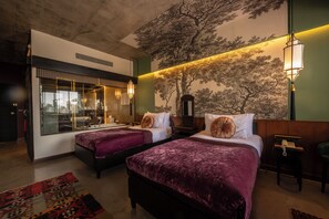 A hotel room with two beds, a large window, a mural, and a telephone on a side table. - Lao Poet Hotel (Vientiane)