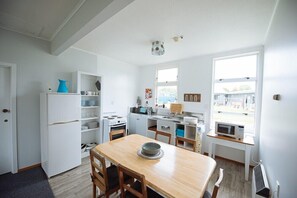 Apartment, 4 Bedrooms | Private kitchen | Full-size fridge, microwave, oven, stovetop
