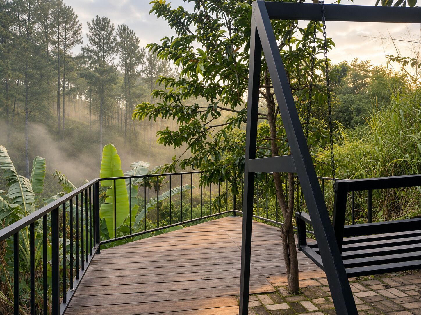 A wooden deck with metal railings, surrounded by lush greenery and trees.