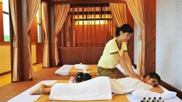 Experience a serene spa treatment on one of two massage tables, attended by a skilled therapist.