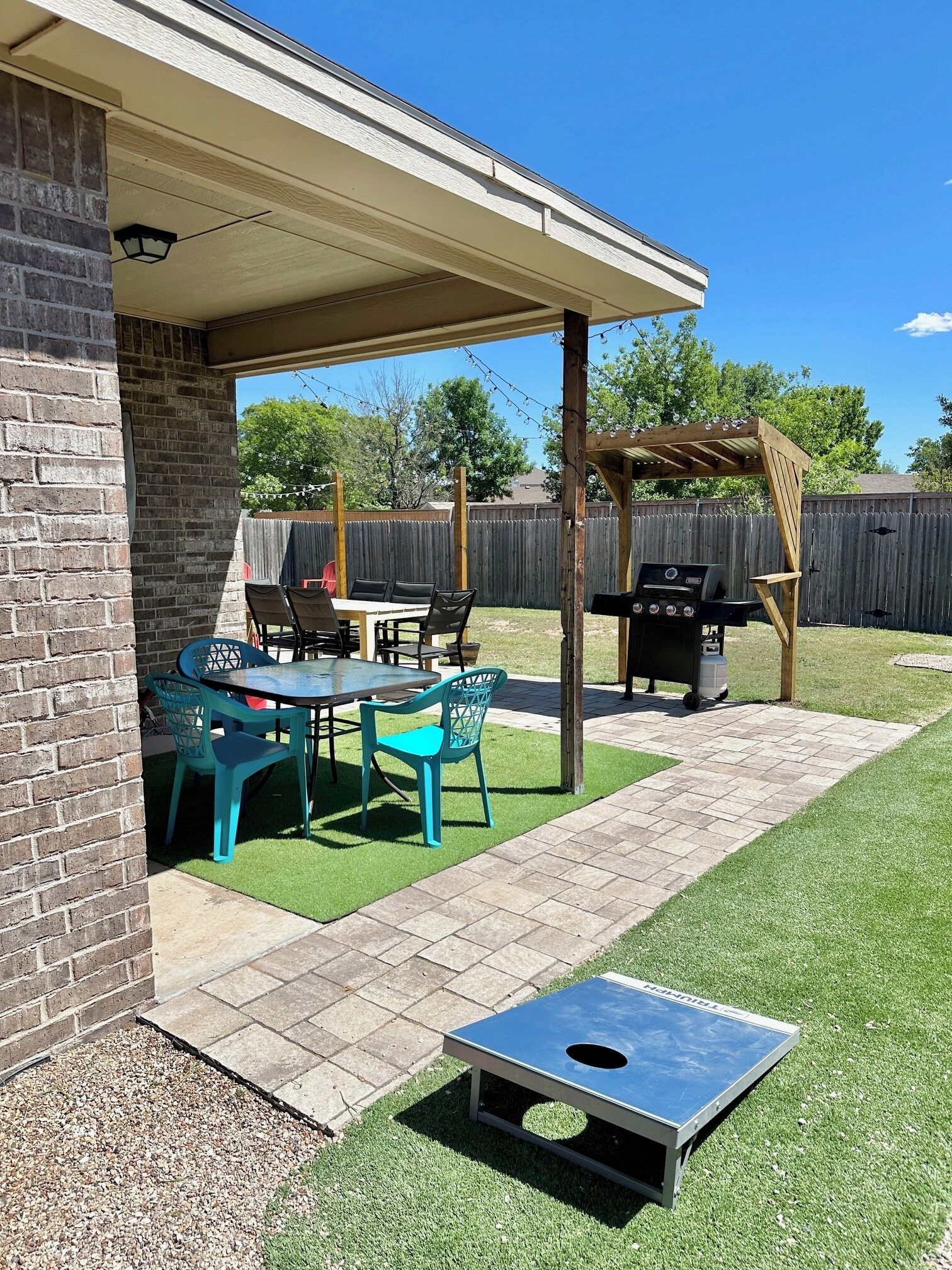 New in 2024: covered grill and outdoor lighting to relax in comfort.