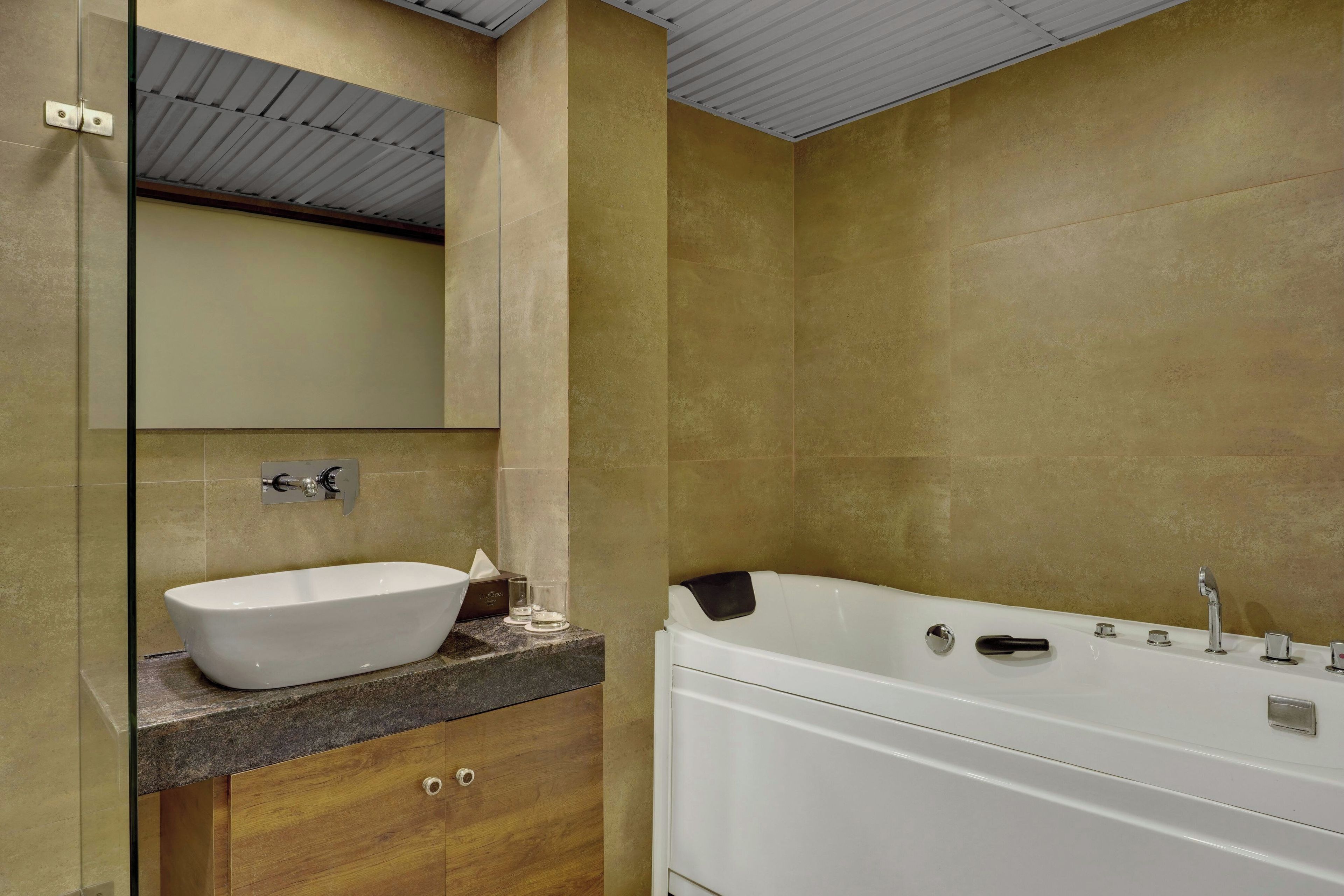 A modern bathroom with a freestanding bathtub, a vessel sink, and a large mirror.