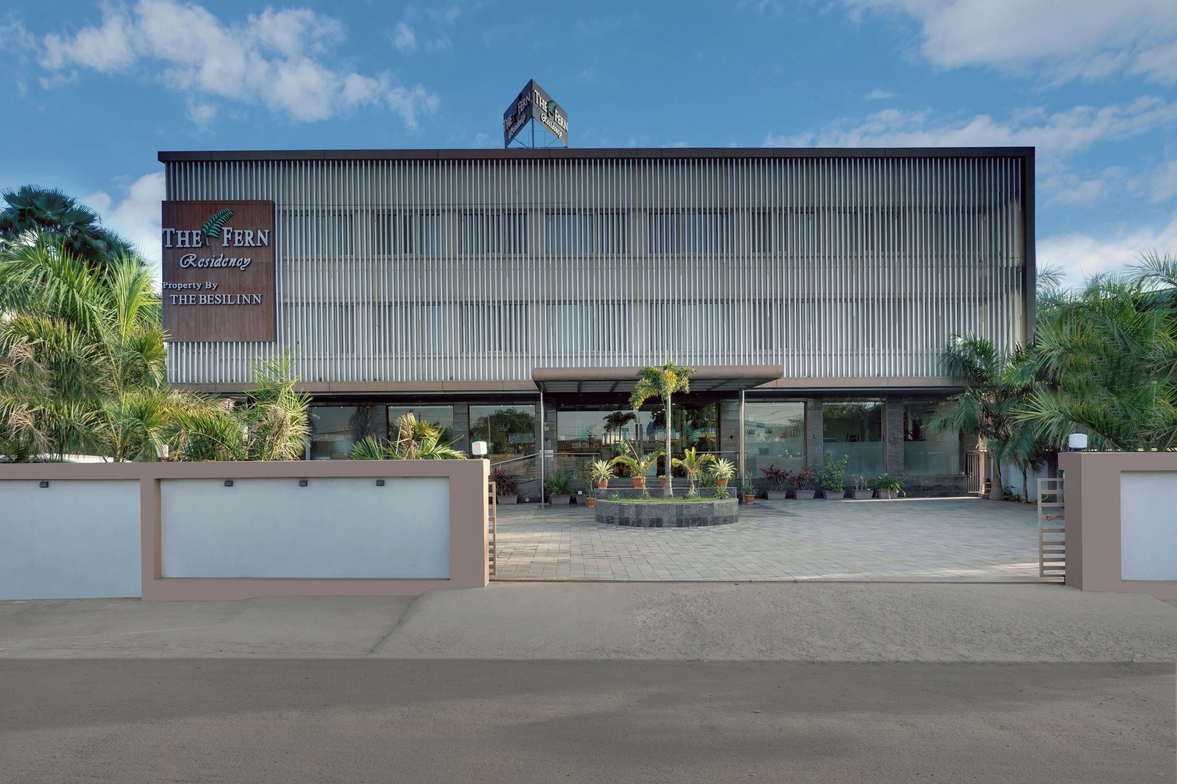 A hotel with a large sign reading 'The Fern Regency' and 'Property By The Besilinn'.