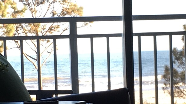 A balcony with a view of the ocean.