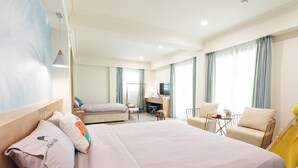 A hotel room with a large bed, a desk, a chair, and a television. - Kiwi Villa (Magong)