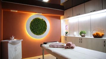 Relax in a stylish room with a circular wall feature, a sink, and a comfortable bed.