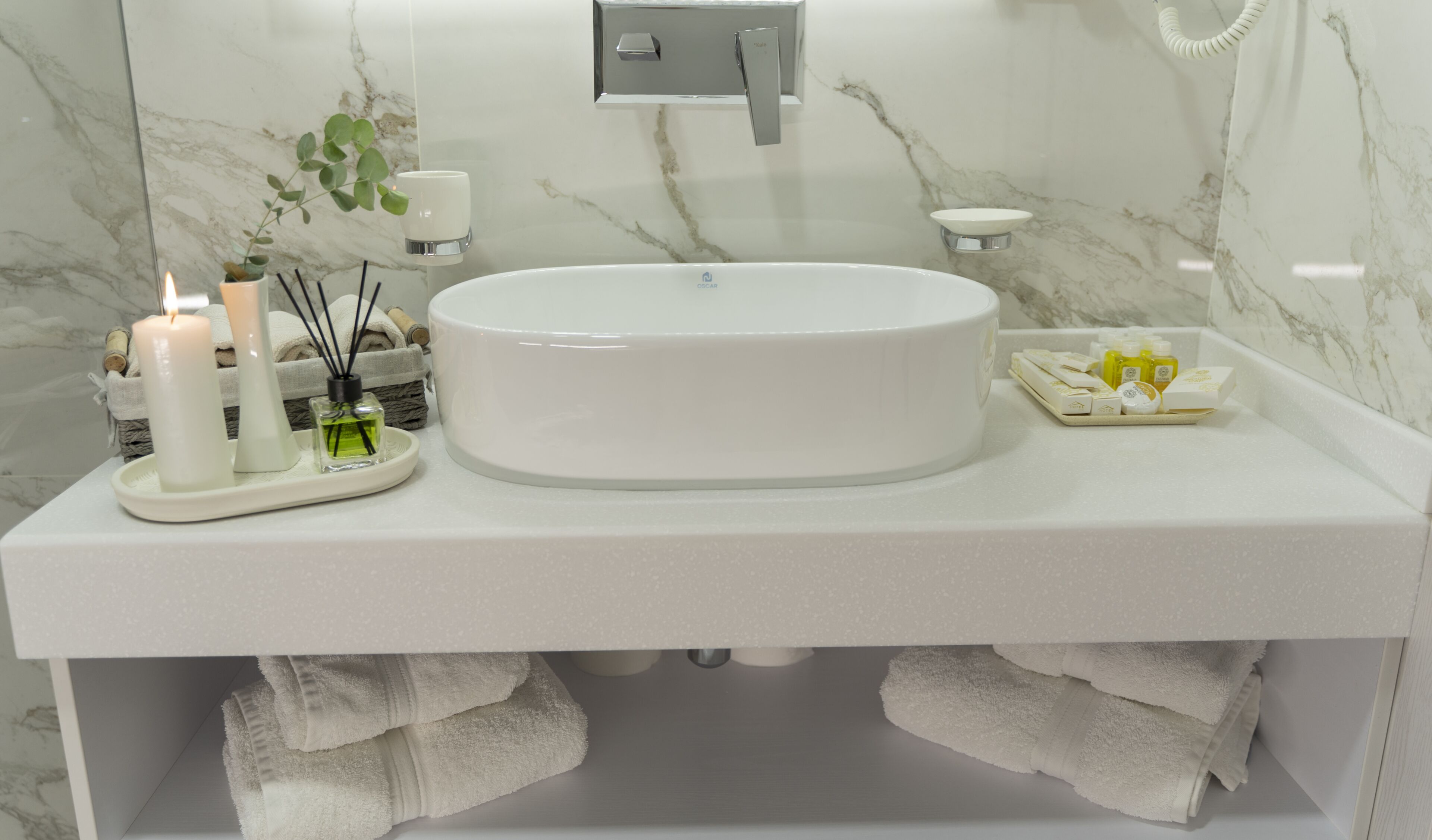 Un baño con un lavabo redondo, un perchero y un jabonera.
