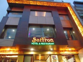 A building with a sign that reads "Saffron Hotel & Restaurant".
