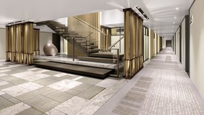 A modern hotel lobby with a central staircase, marble flooring, and a large decorative sphere. - THE MUMIAN HOTEL Shenzhen Luohu (Shenzhen)
