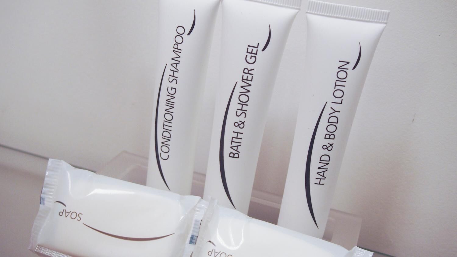 Three toiletry items: conditioning shampoo, bath & shower gel, and hand & body lotion.
