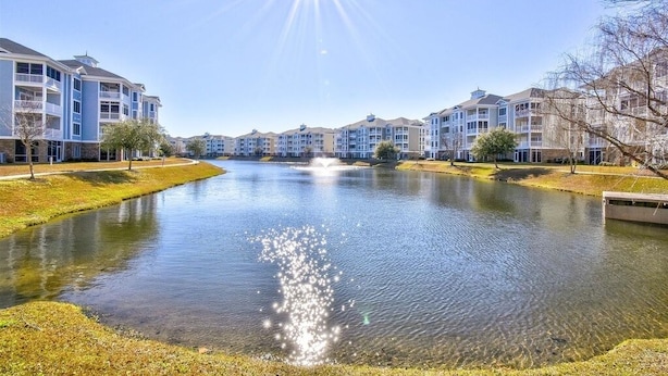 A residential area with a water feature in the center, surrounded by multi-story buildings with balconies. -  Beautiful, Clean condo, new furniture beds carpet TVs. Lake view, private Wifi  (Myrtle Beach)