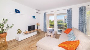 A modern living room with a sofa, TV, and potted plants. - Gorgeous home in Kastel Novi with WiFi (Kastel Novi)