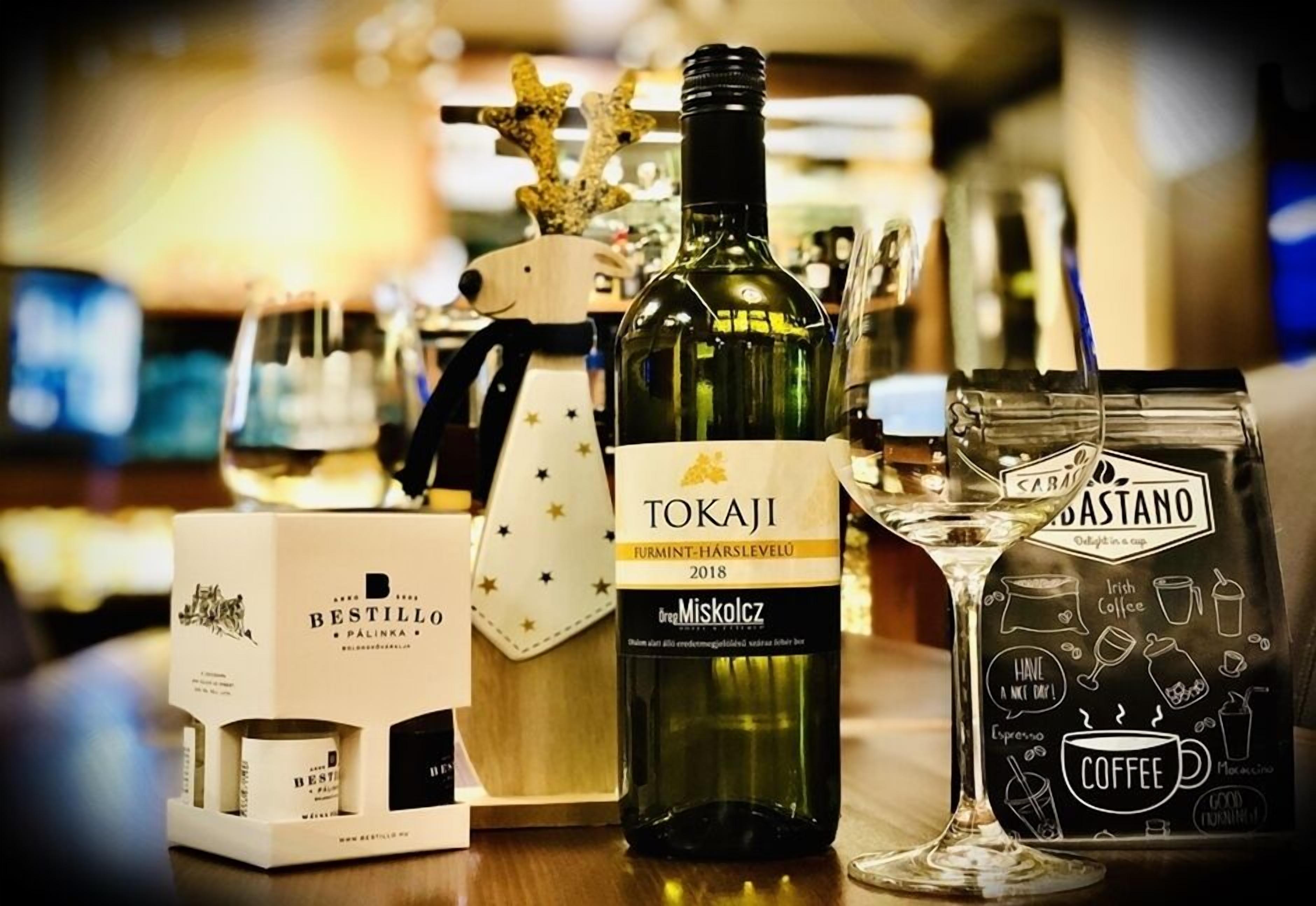A bottle of Tokaji wine, a Bestillo coffee bag, and a glass of coffee.