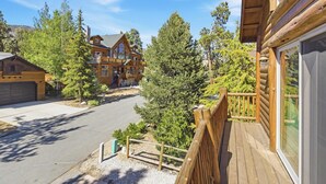 A log cabin with a deck, a garage, and a driveway. - Luxury! 3 Master Suites! Located Near the Lake! Pool Table! Propane BBQ! (Big Bear City)