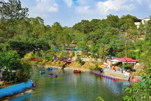 A riverside area with boats, a bridge, and buildings with colorful facades.