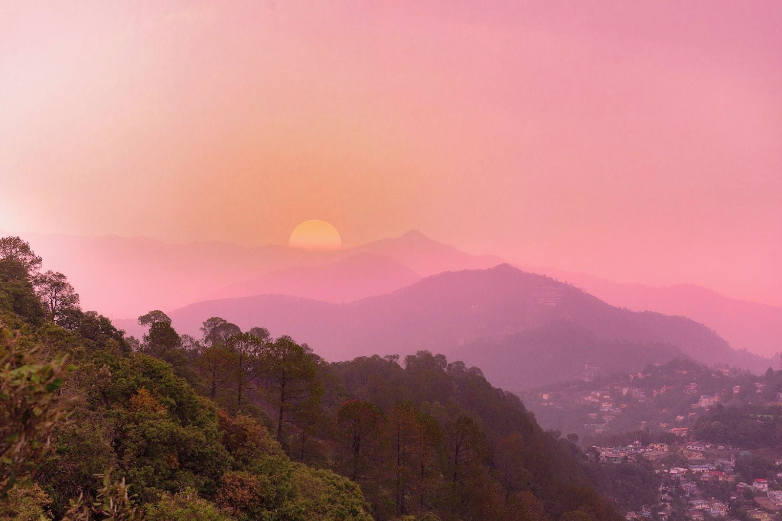 A mountainous landscape with a sunset.