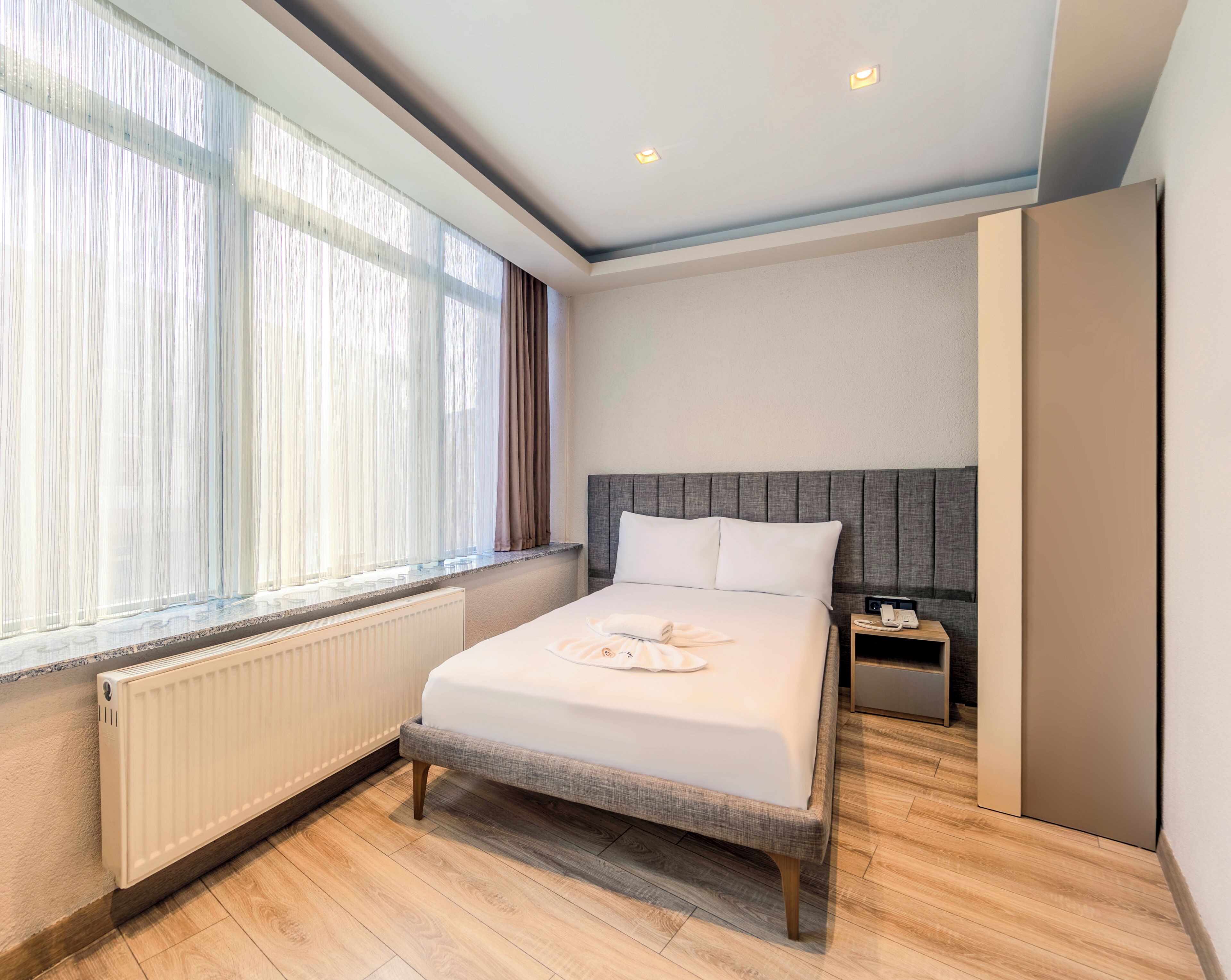 Deluxe Single Room | Premium bedding, desk, laptop workspace, blackout drapes