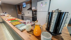 A buffet setup with various food items and beverages. - Evim Hotel (Corlu)