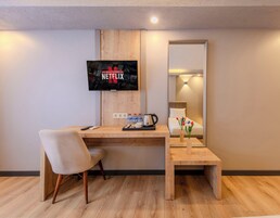 Premium bedding, desk, laptop workspace, blackout drapes