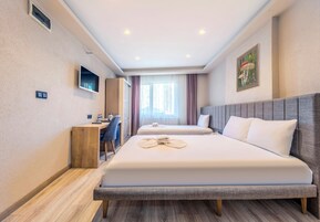 Premium bedding, desk, laptop workspace, blackout drapes