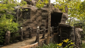 A naturalistic enclosure with a rocky structure, a wooden fence, and a sign indicating the name 'Bija Mattha'. - Tathastu Pench (Kurai)