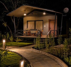 A two-story building with a covered porch, a satellite dish, and a satellite TV logo. - Tathastu Pench (Kurai)