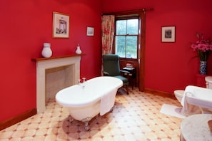 A bathroom with a freestanding bathtub, a toilet, and a chair. - Cambo House And Estate B&B (St. Andrews)