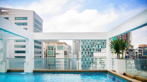 A rooftop swimming pool with a city view, surrounded by modern buildings. - Citylise Studio (Kuala Lumpur)