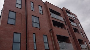 A multi-story brick building with balconies and large windows. - Jaylets Premier Apartments, Leicester. (Leicester)