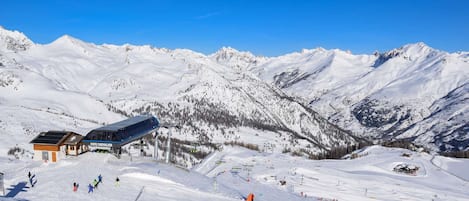 Una stazione sciistica con un edificio con la scritta 'Cote Chevalier' e una pista da sci.