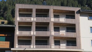 A multi-story building with a modern design, featuring balconies on each floor. - Comfortable apartment in Châtel with balcony for 4 pers. (Châtel)