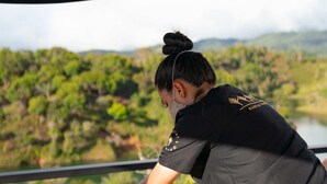 A massage therapy session taking place on a balcony with a scenic view of a forested area. - Bosko (Guatapé)