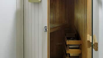 Relax in a serene sauna with a wooden bench and towel rack.