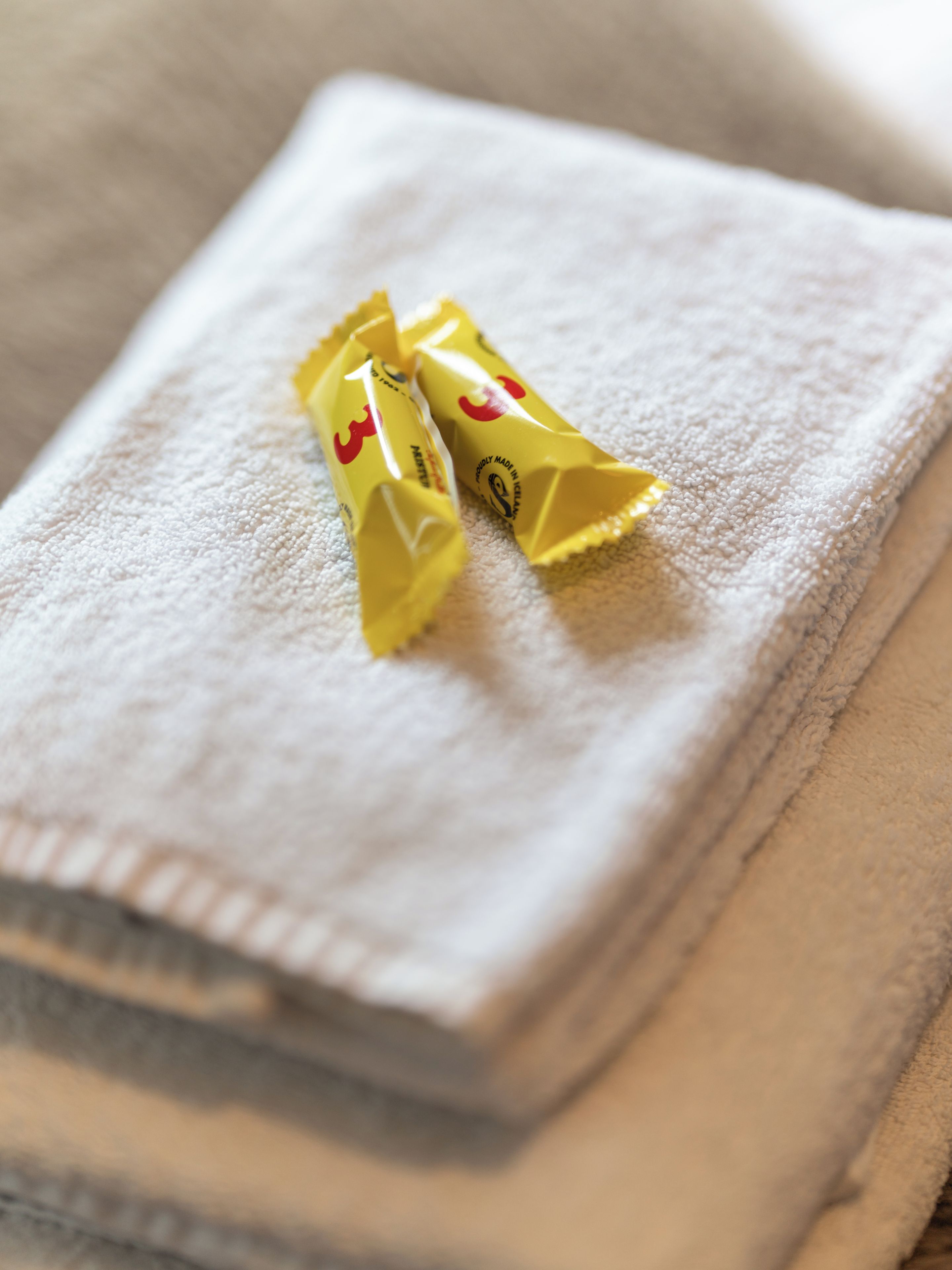 Two yellow packages on a folded white towel.