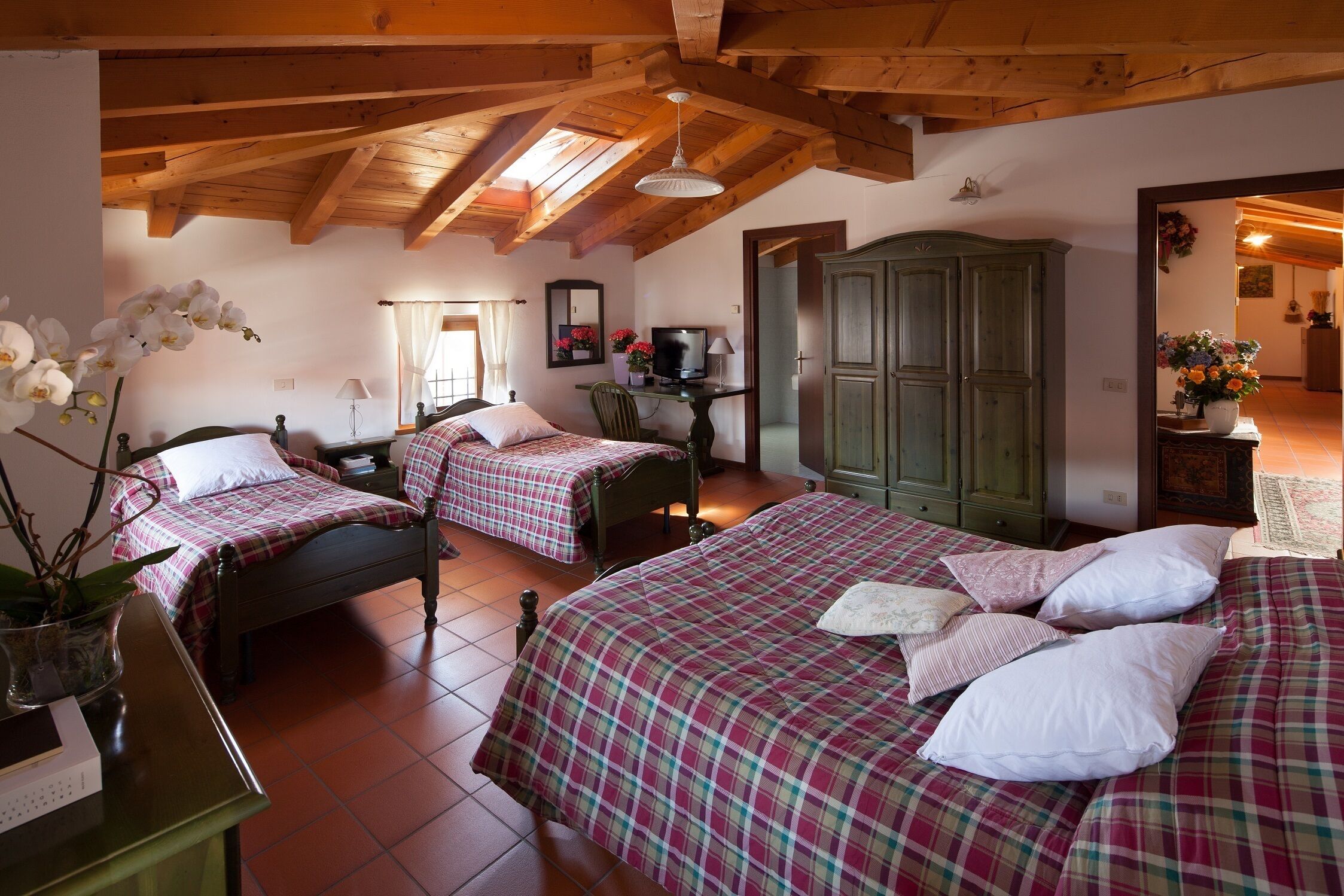 Una camera da letto con due letti, una scrivania, una sedia e un armadio.