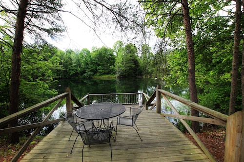 This charming  cozy cottage has a private hot tub, deck for fishing.