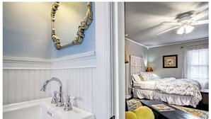 A bathroom with a white sink and a decorative mirror frame. The room has a ceiling fan and a bed with a floral bedspread. - PEACEFUL PRIVATE COTTAGE-WALK TO PARK-5 MINS TO DOWN TOWN (Nashville)