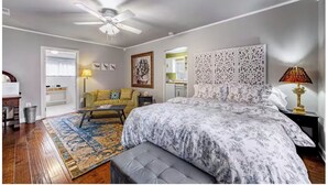 A bedroom with a bed, a sofa, a desk, and a ceiling fan. - PEACEFUL PRIVATE COTTAGE-WALK TO PARK-5 MINS TO DOWN TOWN (Nashville)