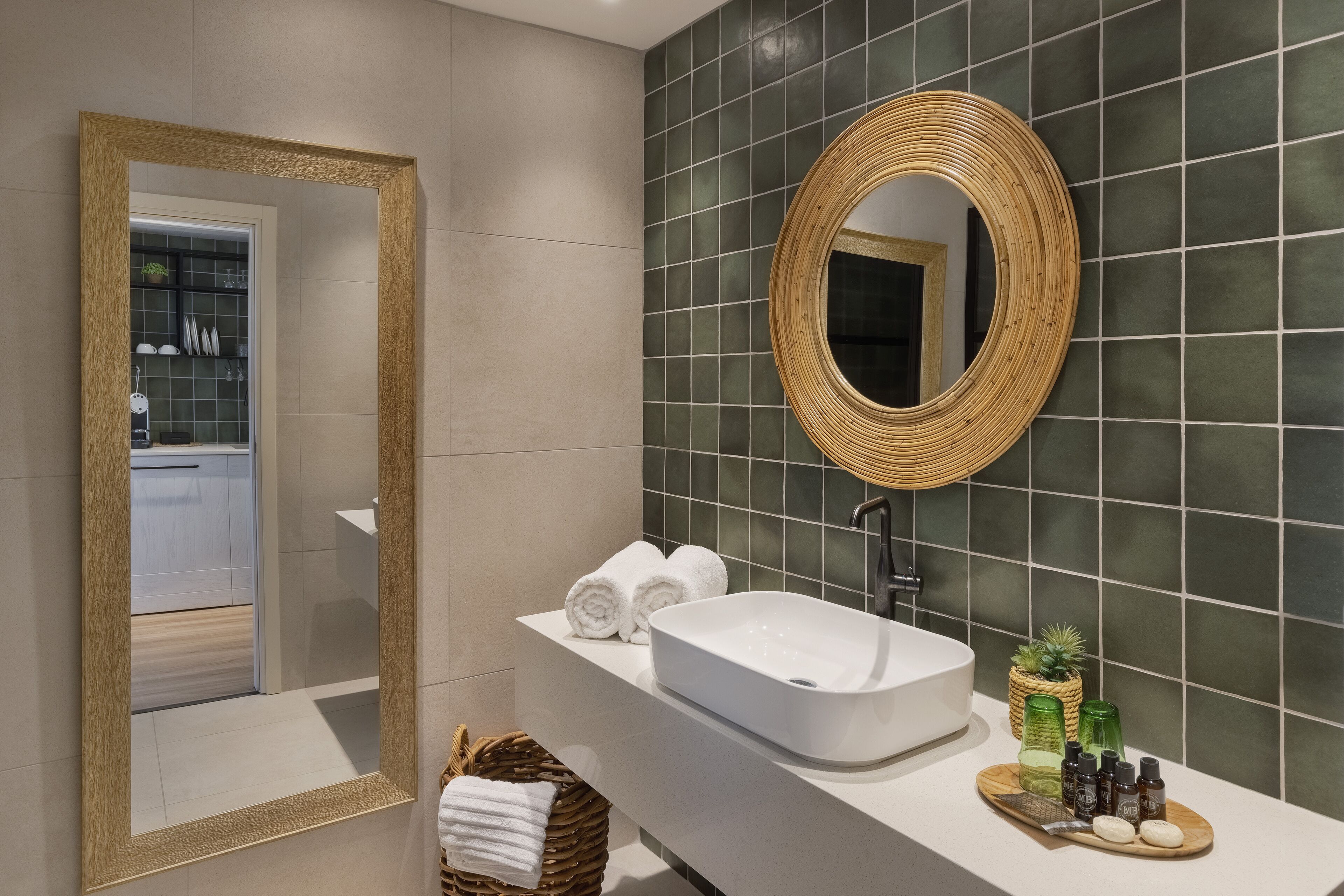 A bathroom with a large mirror, white sink, and a shelf with towels and toiletries.