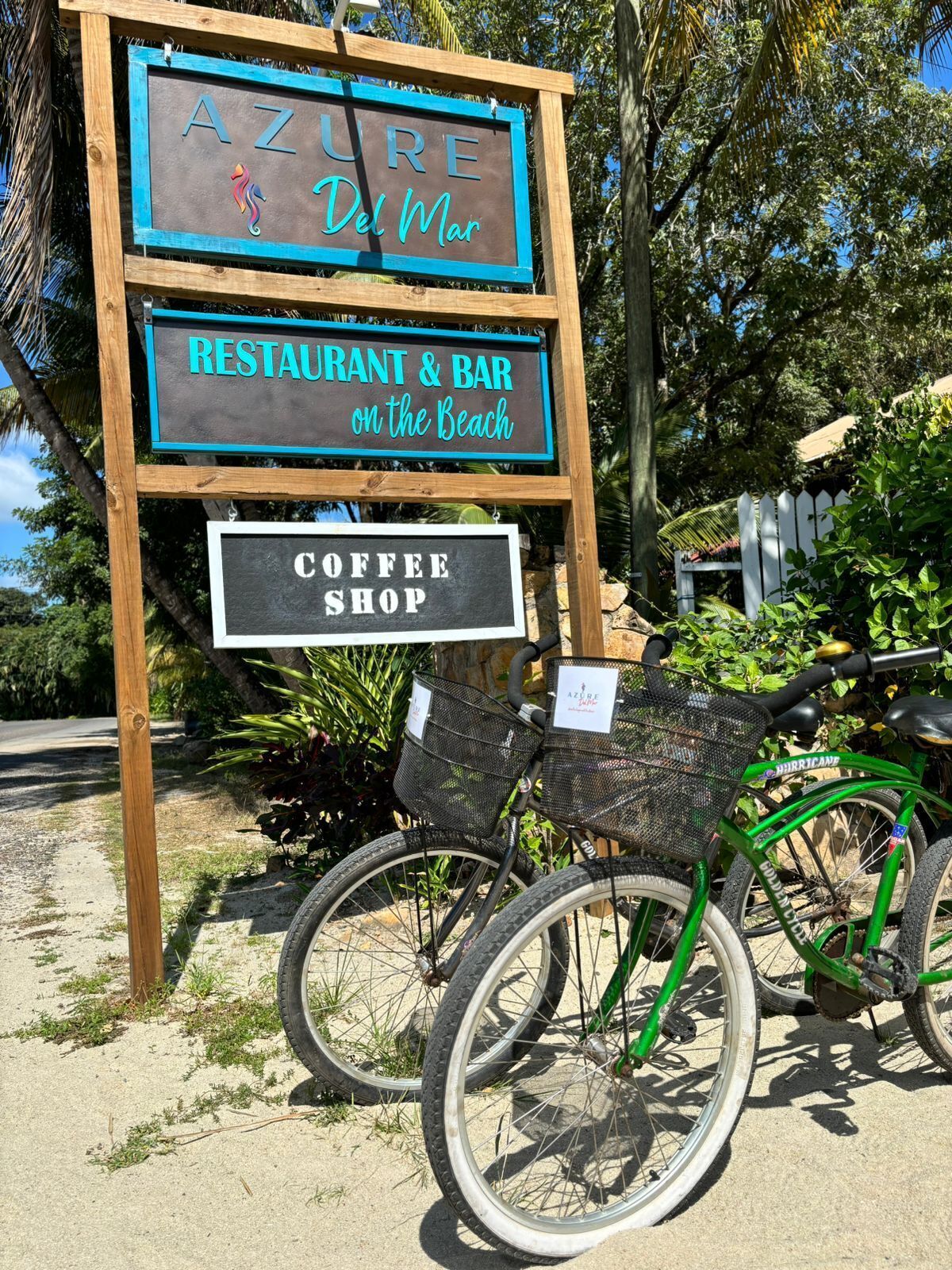 A sign for AZURE Del Mar, a restaurant and bar on the beach, and a coffee shop.