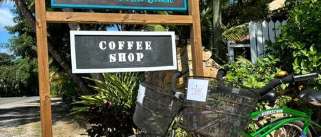 A sign for AZURE Del Mar, a restaurant and bar on the beach, and a coffee shop.