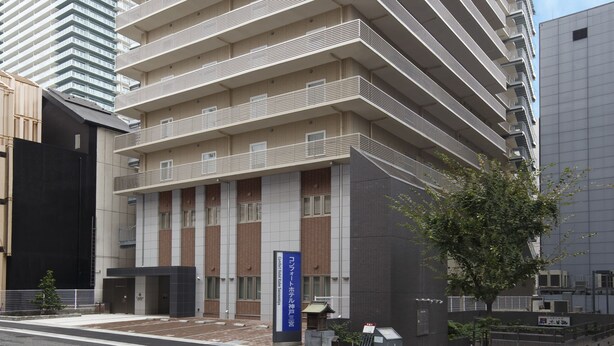 A multi-story hotel with a modern architectural design, featuring a prominent entrance and a sign indicating it is a hotel. - Comfort Hotel ERA Kobe Sannomiya (Kobe)