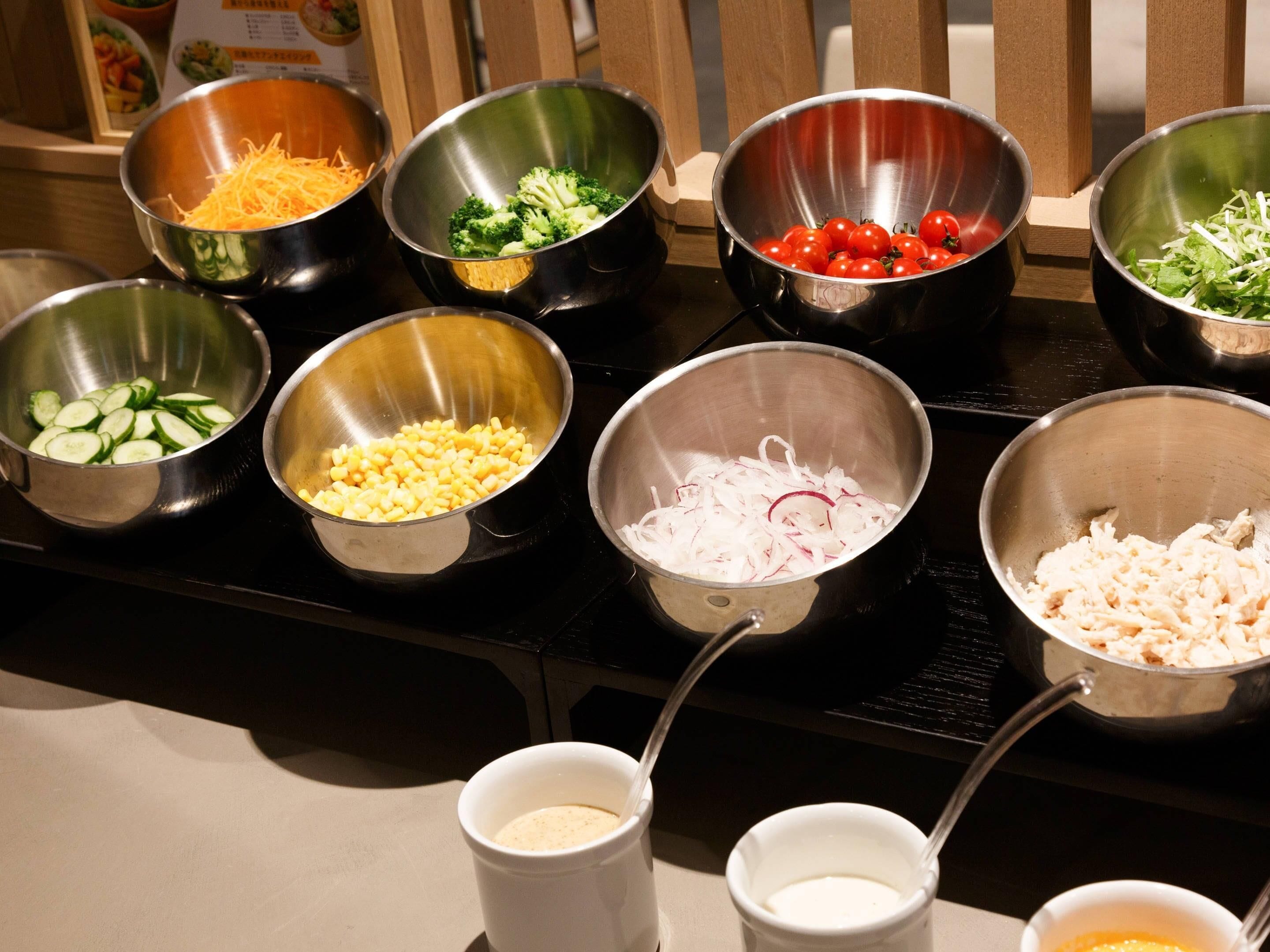 A kitchen counter with various bowls containing different ingredients.