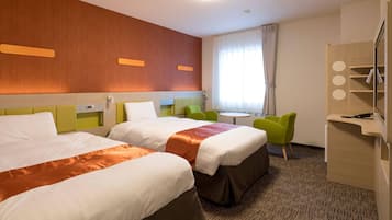 A hotel room with two beds, a desk with a chair, a small table, and a mirror.