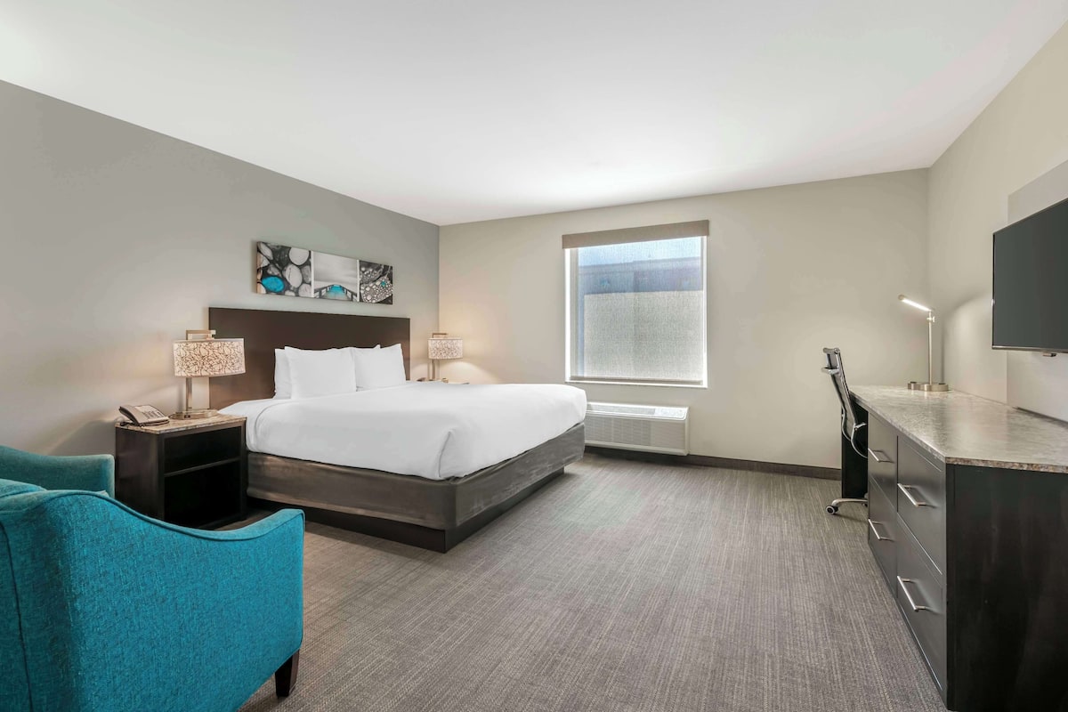 Premium bedding, desk, laptop workspace, blackout drapes