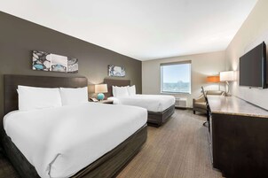 Premium bedding, desk, laptop workspace, blackout drapes