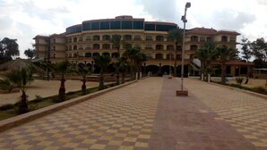 A large, multi-story building with a central courtyard. - Fayed Armed Forces Hotel (Fayed)