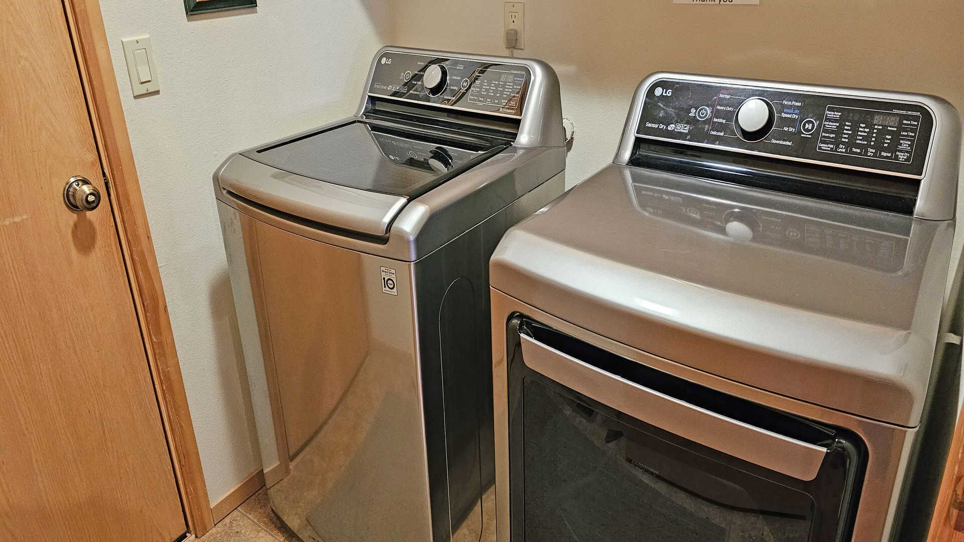 A compact laundry room with two stacked washers and a dryer.